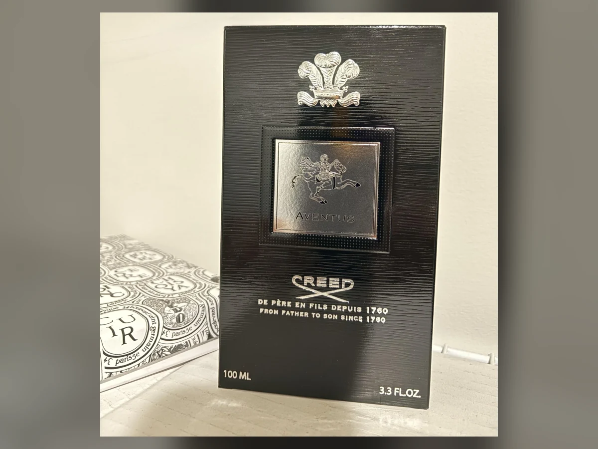 Creed Aventus bottle beside its exact Creed Aventus packaging
