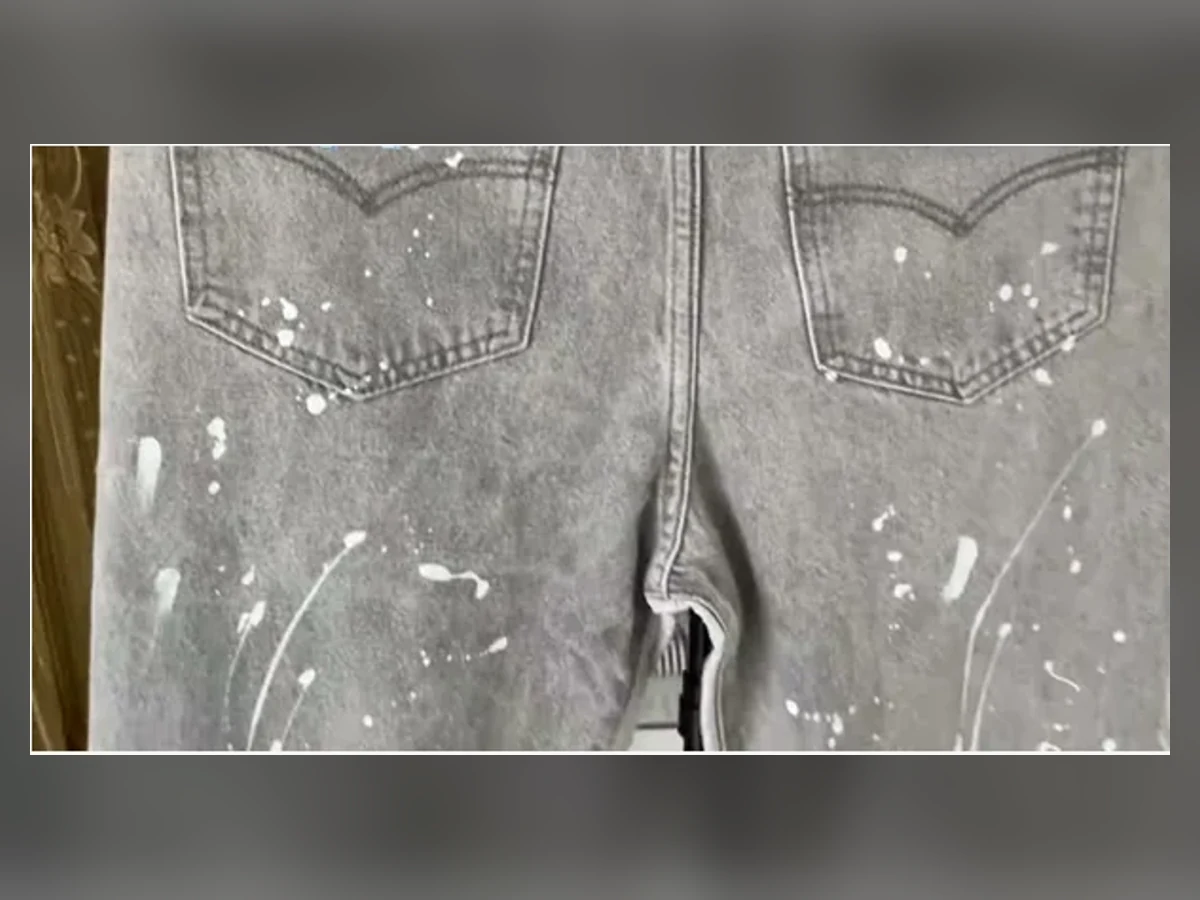 Close-up of the exact Gallery Dept paint-splatter jeans